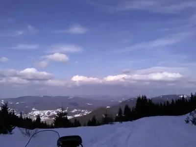 a view of a snow covered mountain with a road at Ski Chalets at Pamporovo - an affordable village holiday for families or groups in Pamporovo
