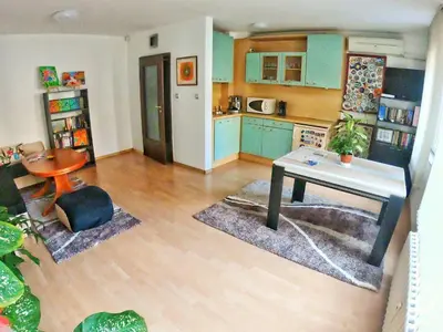 a kitchen with blue cabinets and a table in it at Art31 in Sofia