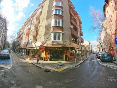 a tall building on a city street with cars parked at Art31 in Sofia