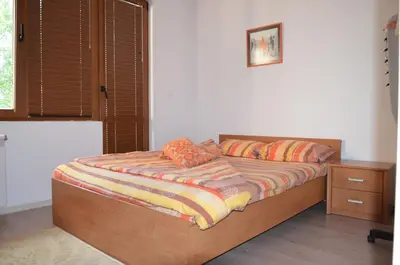 a bed with two pillows on it in a bedroom at Bulhotel Pritzker Apartment in Sofia