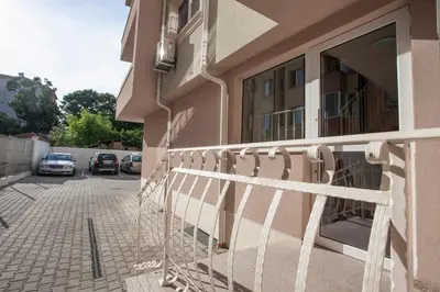 a balcony of a building with cars parked in a parking lot at ApArt apartments in Plovdiv