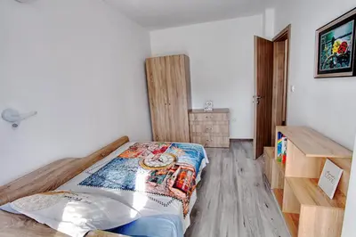a bedroom with a bed and a wooden desk at ApArt apartments in Plovdiv