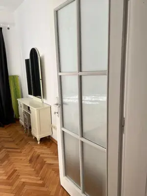 a sliding glass door in a room with a television at Apartment August 11 in Sofia