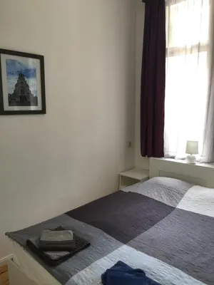 a bedroom with a bed and a window at Apartment August 11 in Sofia
