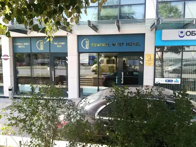 a car parked in front of a building at Central West Hotel in Sofia