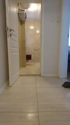 a hallway with a bathroom with a shower and a door at Solunska Apartment in Sofia
