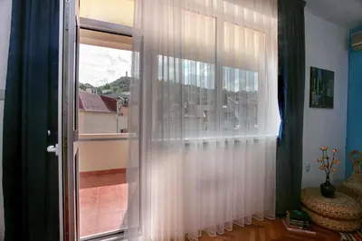 a window with white curtains in a room at TERRACE HOME - Three bedrooms City center in Plovdiv