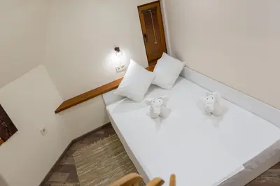two stuffed elephants sitting on a bed in a room at Central Loft in Plovdiv