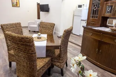 a dining room with a table and wicker chairs at Central Loft in Plovdiv