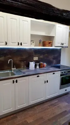 a kitchen with white cabinets and a sink at Central Loft in Plovdiv