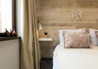 a bedroom with a bed and a wooden wall at Luxury Central Apartment in Plovdiv