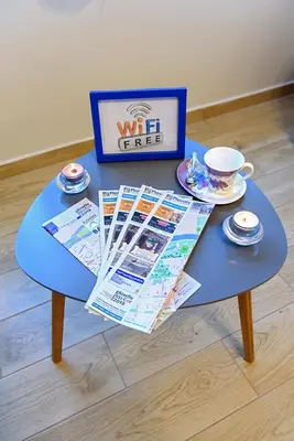 a blue table with a cup of coffee and magazines on it at Apartment Iris in Plovdiv
