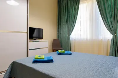 a bedroom with a bed with blue towels on it at Apartment Iris in Plovdiv