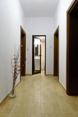 a hallway with two doors and a vase with flowers in it at Apartment Iris in Plovdiv