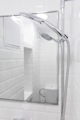 a bathroom with a shower with a sink and a toilet at Vinyl Studio Apartment Sofia in Sofia