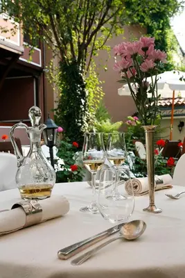 a table with glasses of wine on a table at Old Legends Hotel in Plovdiv