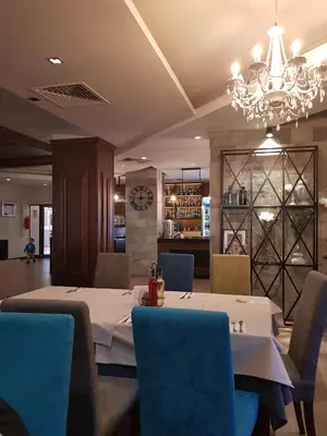 a dining room with a table and chairs and a chandelier at Belvedere holiday apartment in Bansko