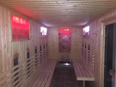 a empty room with wooden walls and red lights at Belvedere holiday apartment in Bansko