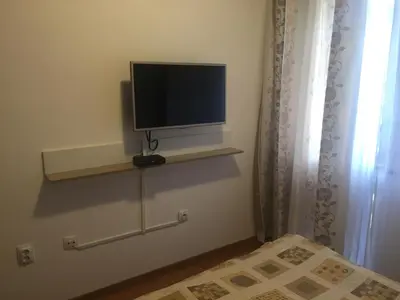 a television sitting on a shelf in a room at Belvedere holiday apartment in Bansko