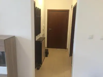a hallway with a brown door and a tile floor at Belvedere holiday apartment in Bansko