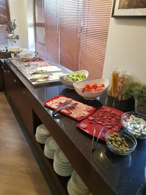 a kitchen counter with plates and bowls of food at Belvedere holiday apartment in Bansko