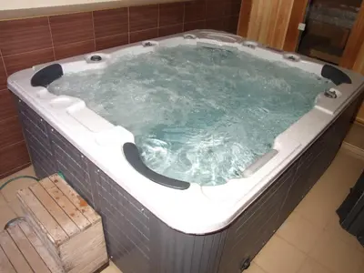 a large jacuzzi tub in a bathroom at Family Hotel Dalia in Velingrad