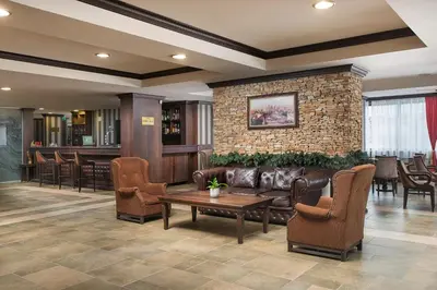 a lobby with a couch and chairs and a bar at Royal Park Hotel by Astoria Collection in Bansko
