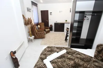 a bedroom with a bed and a living room at Snow Pearl Residence & FREE SPA in Bansko