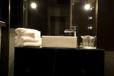 a bathroom with a laptop on a counter with towels at Hotel Fashion - Free Parking in Sofia