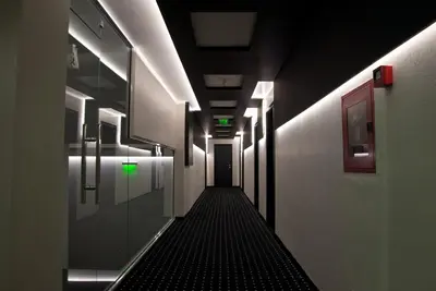 a long hallway with green lights in a building at Hotel Fashion - Free Parking in Sofia