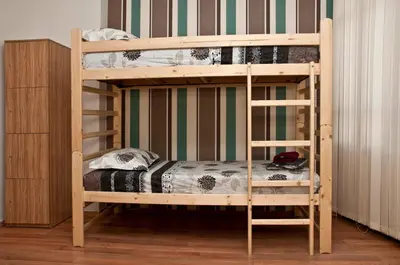 a bunk bed with a wooden bunk bed frame in a room at Hostel Mostel Hub Rooms and Apartments in Sofia