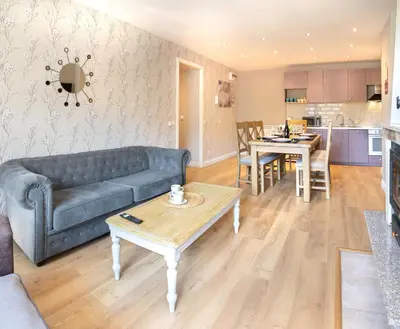 a living room with a couch and a table at Predela 2 Aparthotel in Bansko