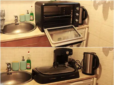 a kitchen with a sink and a microwave and a toaster oven at Botev Apartment in Sofia