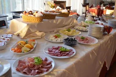a long table with plates of food on it at Hotel Bankya Palace in Bankya