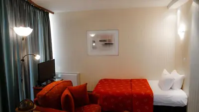 a hotel room with a bed and a chair at Hotel Bankya Palace in Bankya