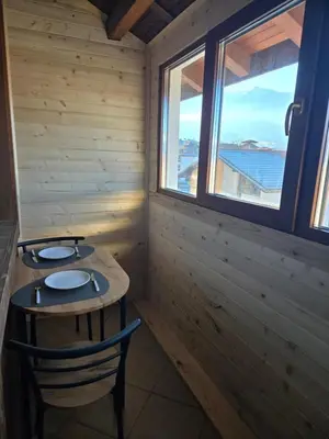 a room with a table and two chairs and a window at Pirina Club Hotel in Bansko