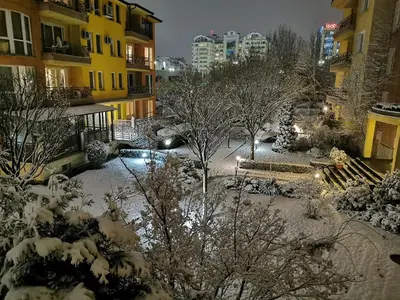 a courtyard covered in snow with buildings and trees at Aparthouse Borovo near Bulgaria Mall, free street parking in Sofia