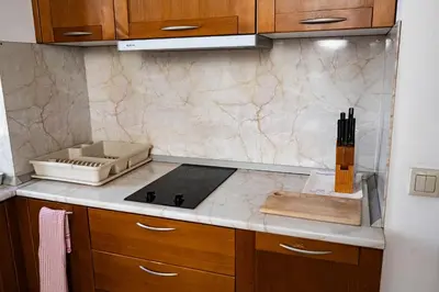 a kitchen with a stove and a counter top at St. John Hill Apartment, Bansko in Bansko