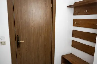 a wooden door in a room with stairs at St. John Hill Apartment, Bansko in Bansko