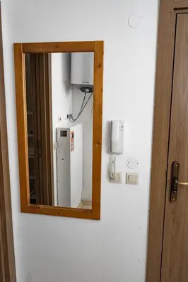 a mirror hanging on a wall in a room at St. John Hill Apartment, Bansko in Bansko