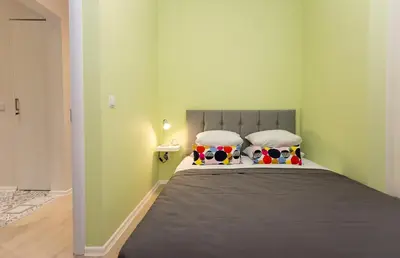 a bedroom with a bed with two pillows on it at The Cozy Apartment, Sofia in Sofia