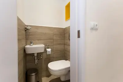 a small bathroom with a toilet and a sink at The Cozy Apartment, Sofia in Sofia