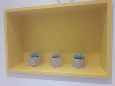 three potted plants sitting on a yellow shelf at The Cozy Apartment, Sofia in Sofia
