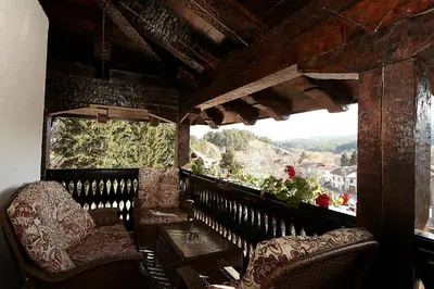 a room with chairs and a window with a view at Family hotel Makedonska Kruchma in Dobrinishte