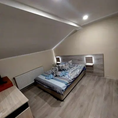 a bedroom with a bed in a room at Guesthouse Pumpalovi in Dobrinishte