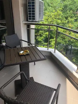 a balcony with a table and chairs and a heater at Apartment Trimontium 2 in Plovdiv