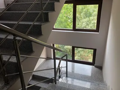 a staircase in a house with a large window at Apartment Trimontium 2 in Plovdiv