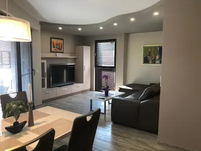 a living room with a couch and a tv at Apartment Trimontium 2 in Plovdiv