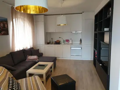 a living room with a couch and a table at St. Seraphim's Apartment in Sofia