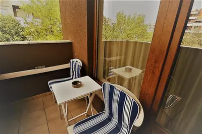a pair of chairs and a table on a balcony at St. Seraphim's Apartment in Sofia